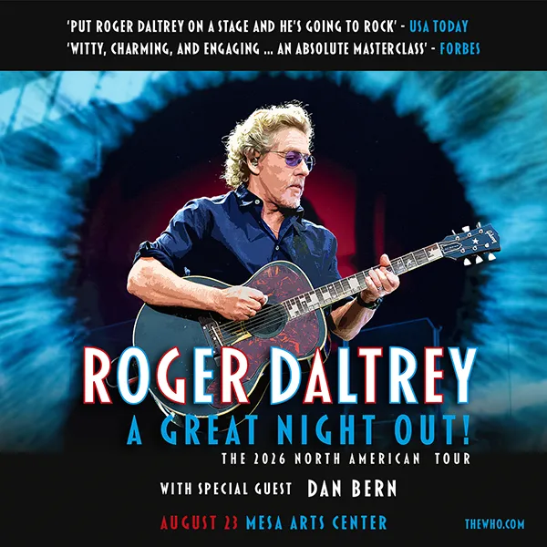 Roger Daltrey playing guitar on stage