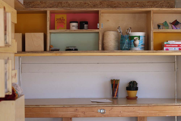 Shelves inside MABEL trailer with art supplies