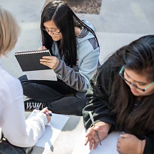 Students writing in notebooks